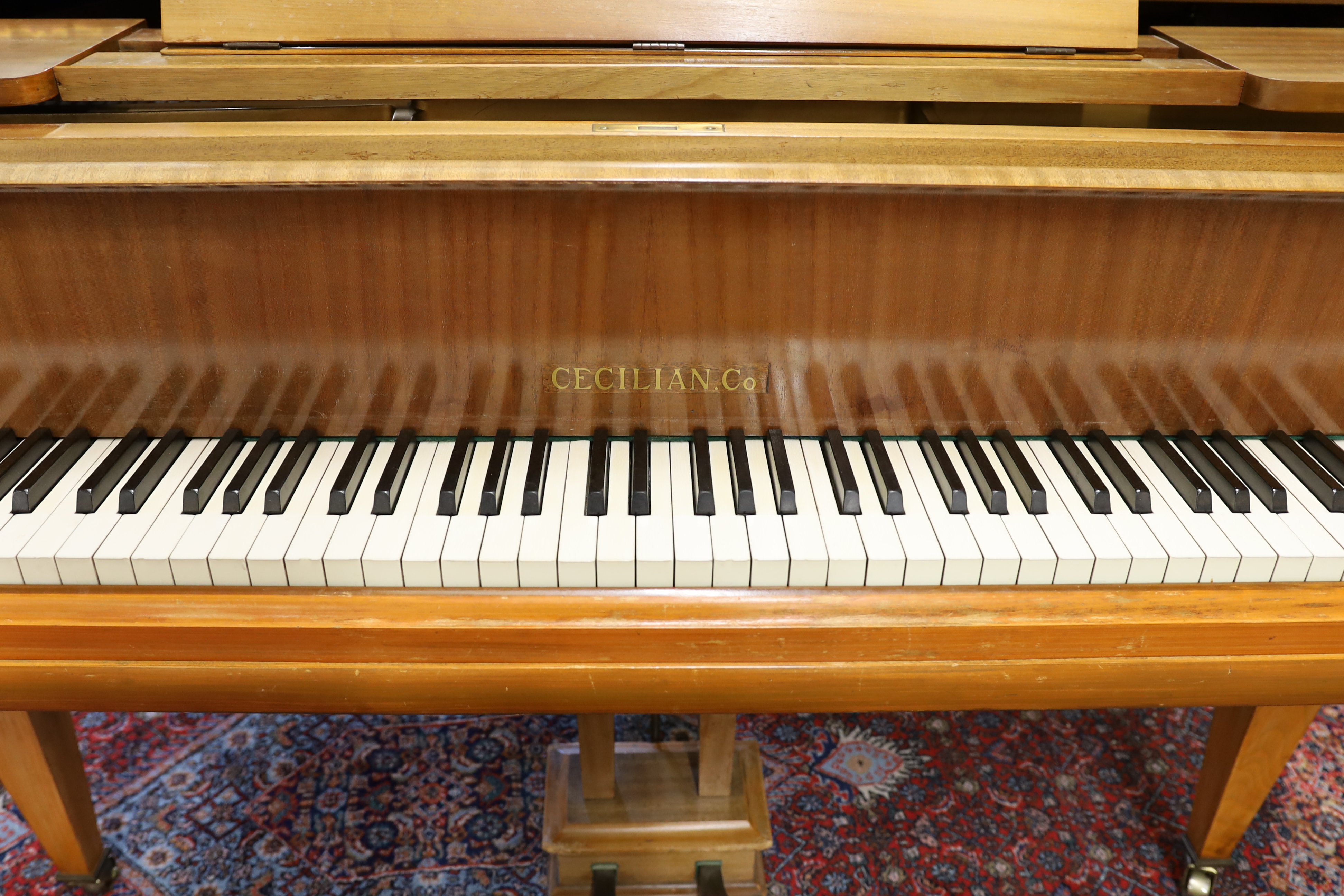 A mid 20th Cecilian & Co mahogany baby grand piano retailed by Harrods Ltd